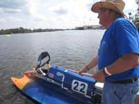 John holds the boat in a slightly diagonal position